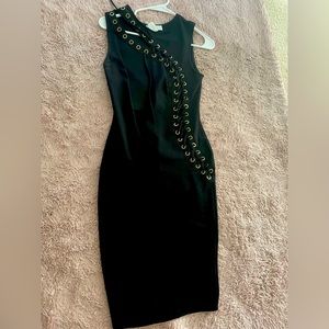 Black dress w symmetrical openings around the chest and down the side.